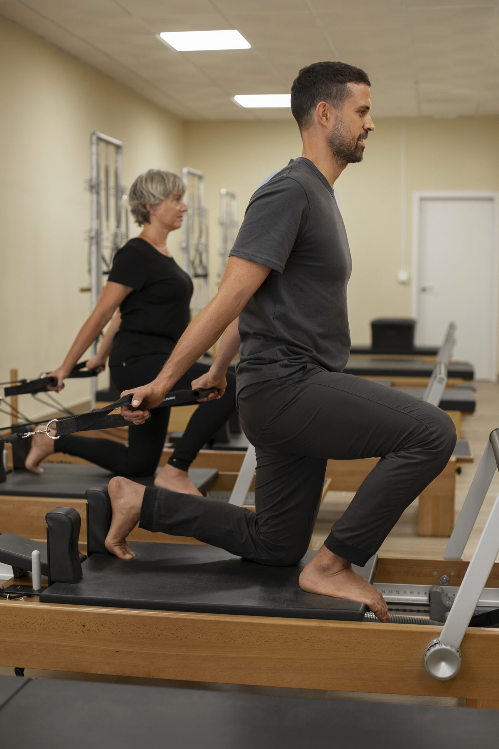 side-view-man-old-woman-pilates-class